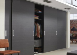 Sliding wardrobes with warm wood detailing
