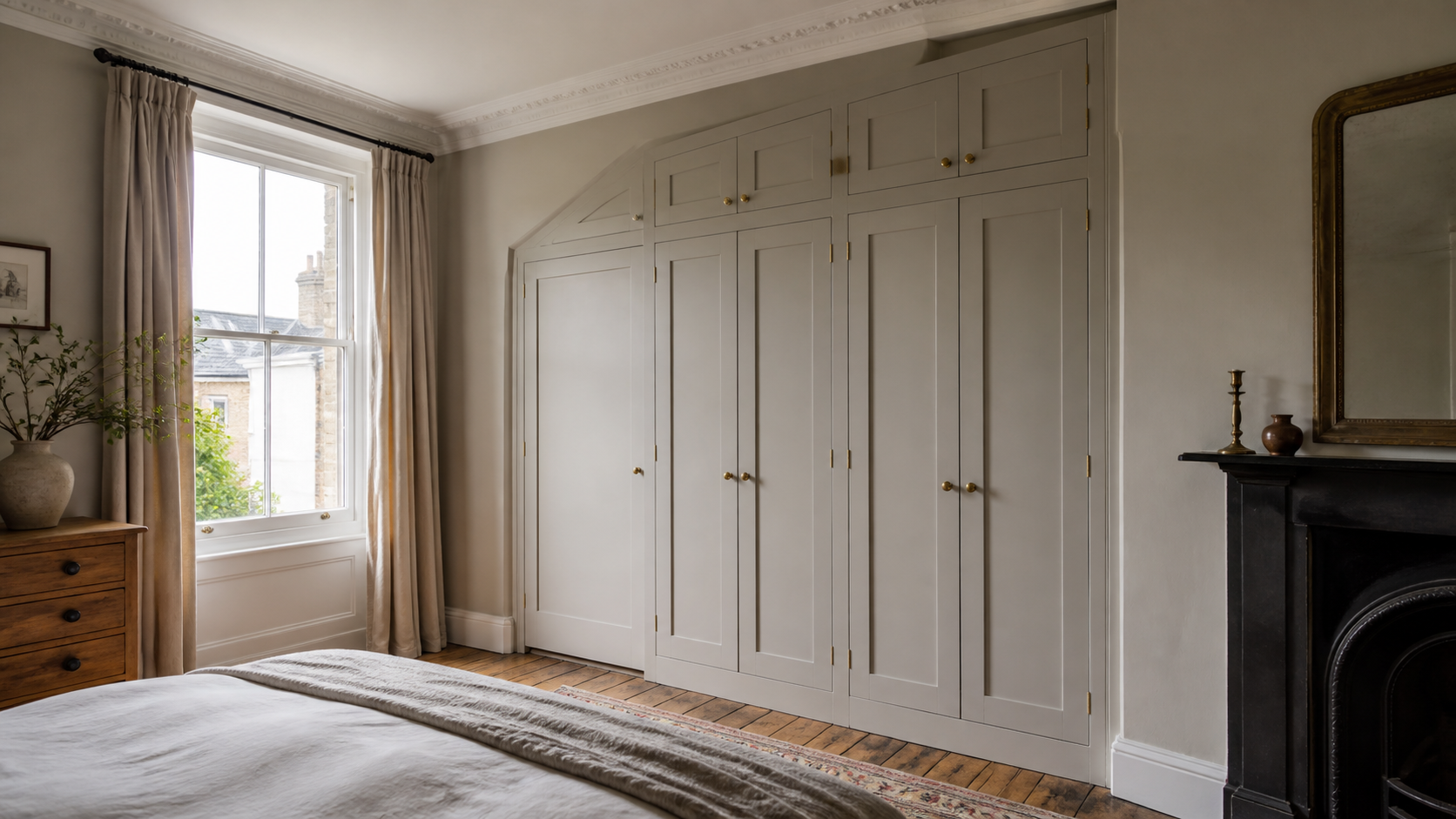 Bespoke fitted wardrobe built into an alcove in a period home